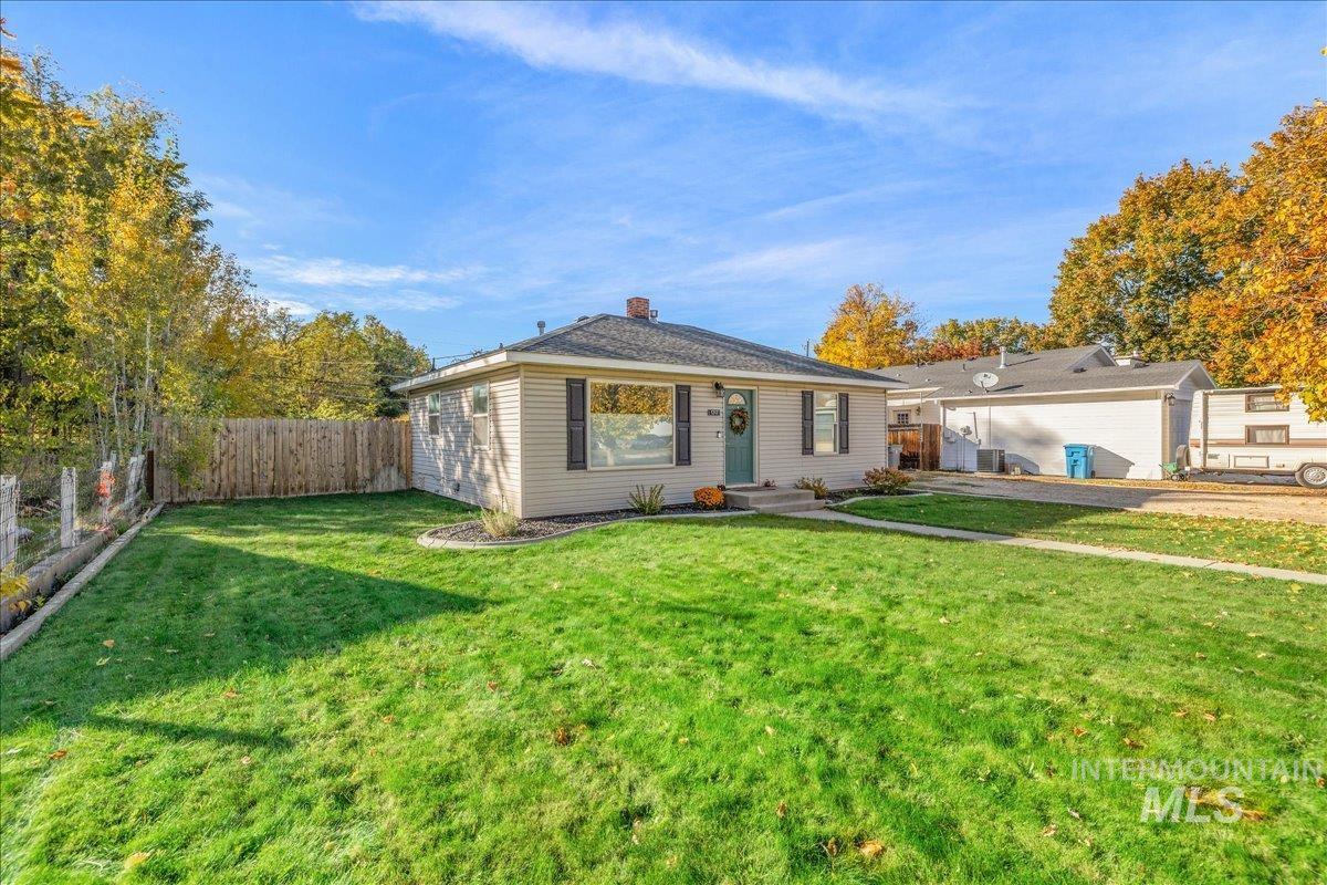 View of front of home with a fenced backyard and a chimney