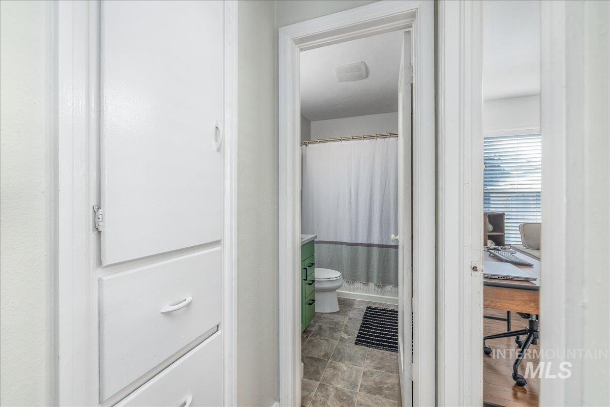 Bathroom featuring a shower with curtain and vanity