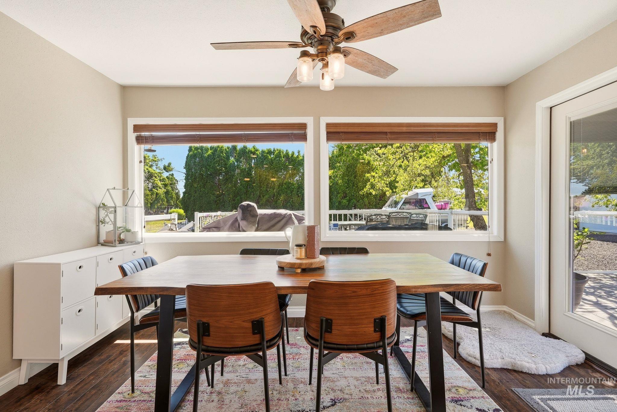 Dining area featuring wood-finish flooring and a ceiling fan with integrated lighting