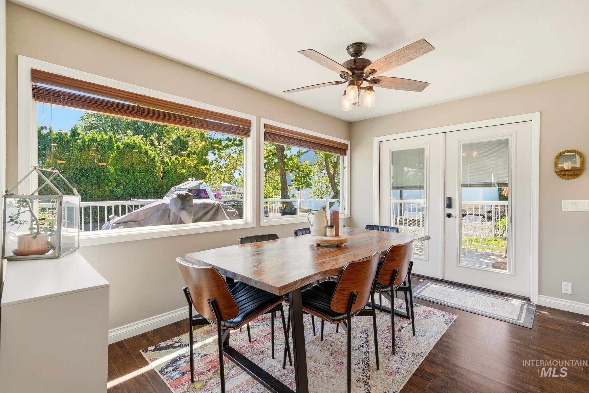 Dining area featuring wood-finish flooring and a ceiling fan with integrated lighting