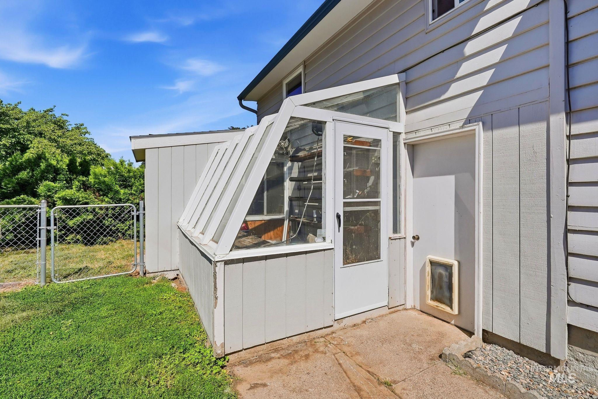 Integrated greenhouse structure with an exterior access door