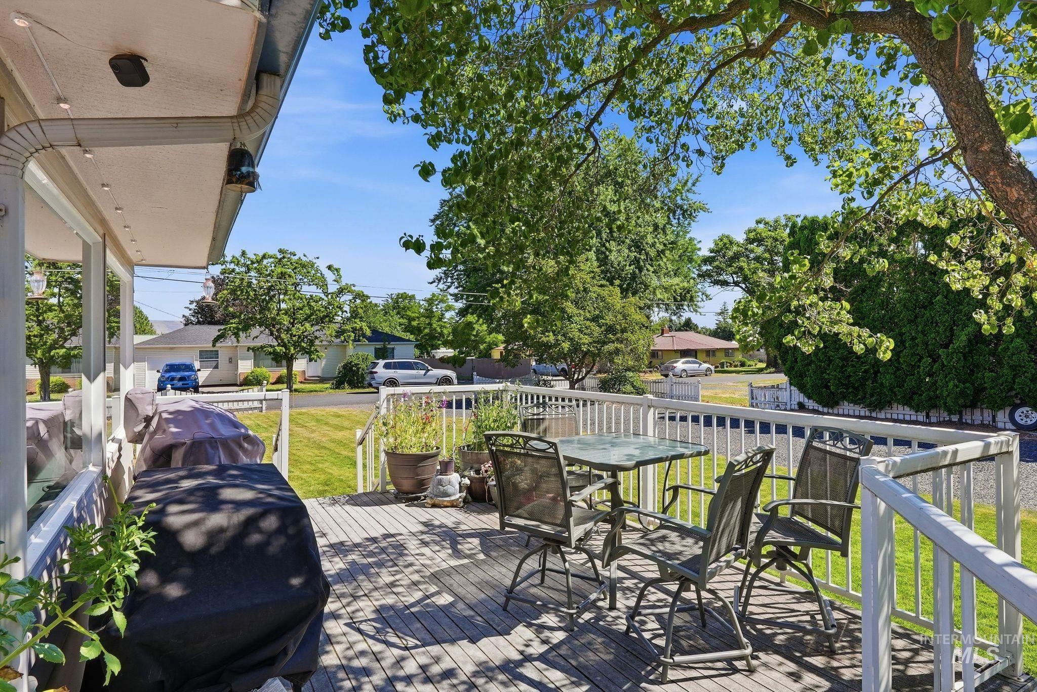 Spacious outdoor deck featuring wood-finish flooring and white railings