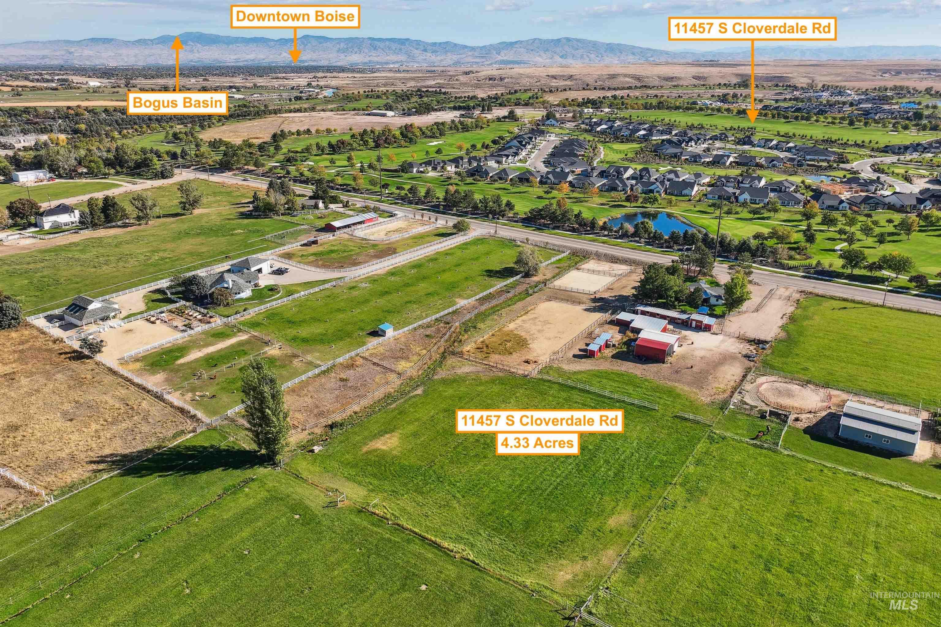 Aerial view of property and surrounding area with a mountain backdrop and nearby suburban area