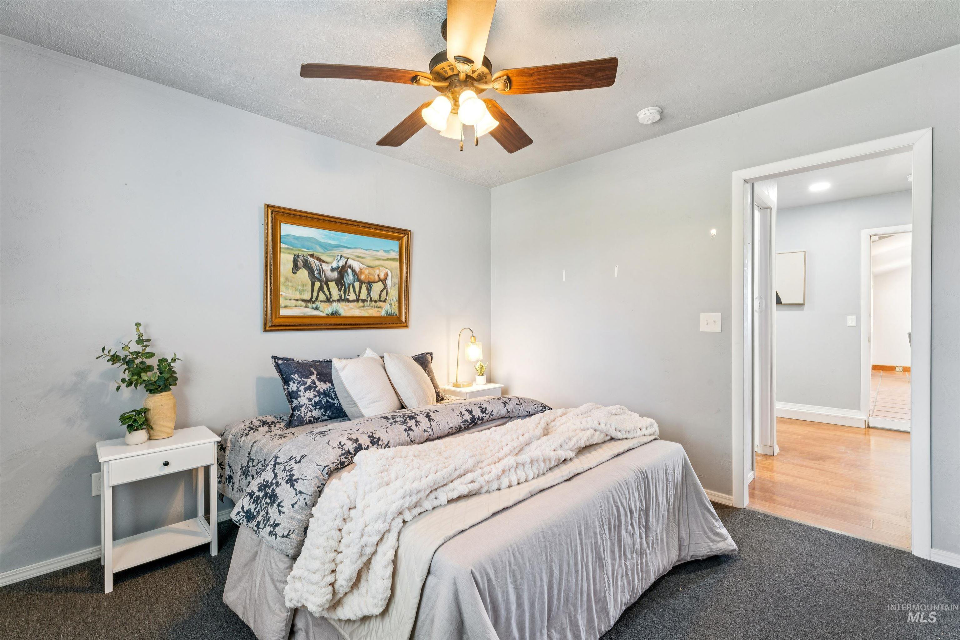 Bedroom featuring a ceiling fan and carpet flooring