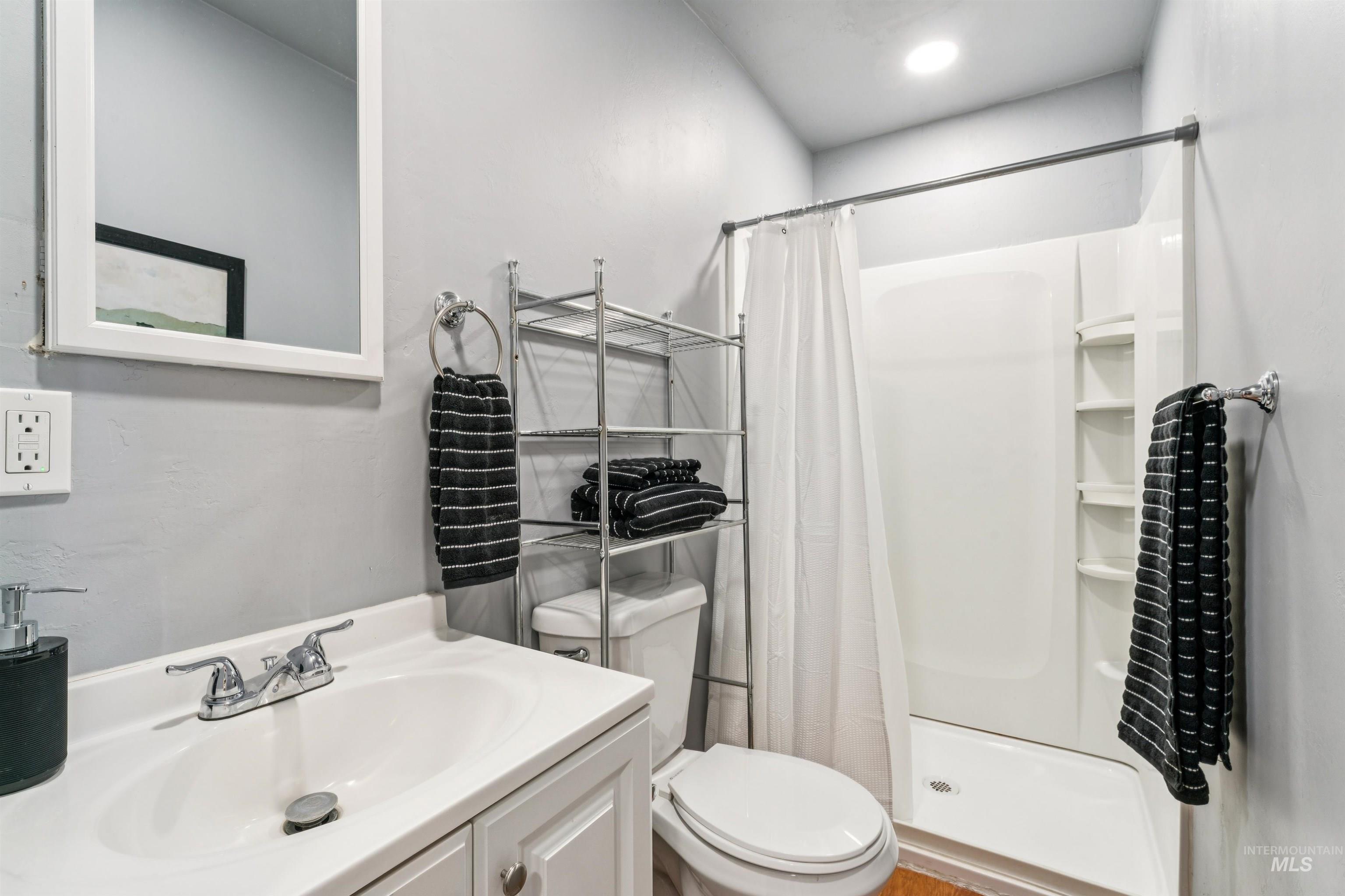 Full bath with a stall shower and vanity