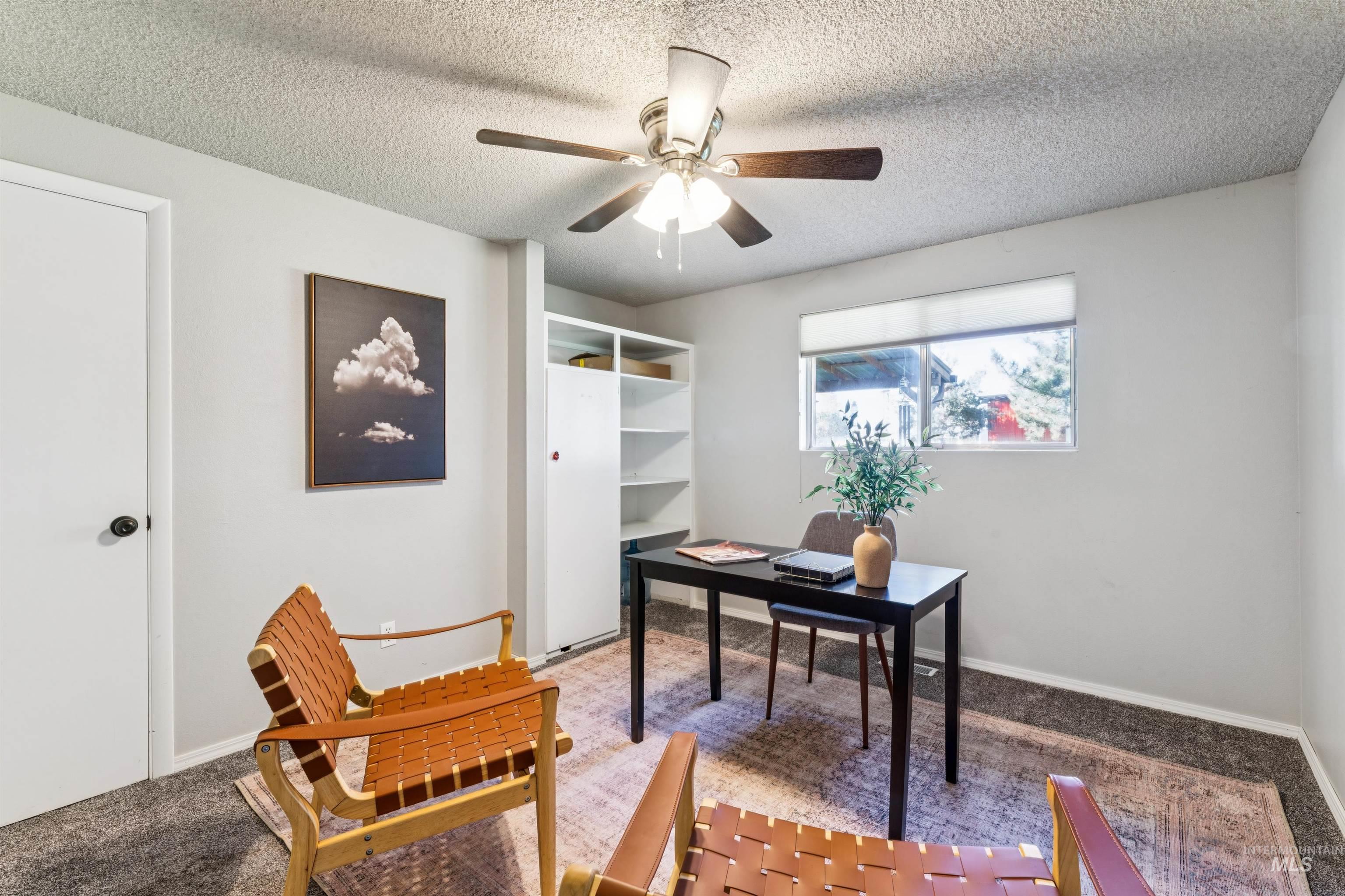 Office space with carpet floors, a textured ceiling, and ceiling fan