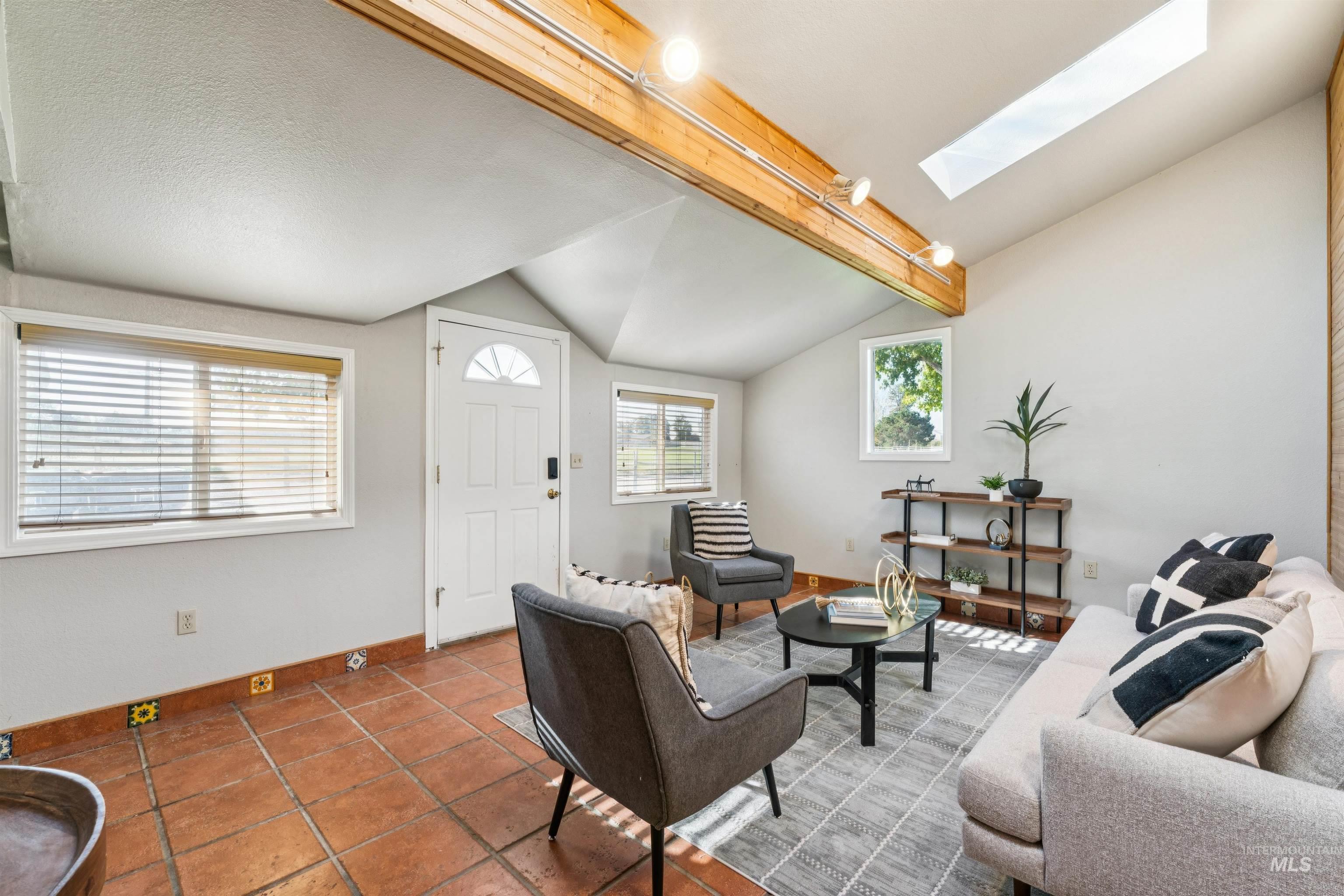 Living area featuring a skylight and tile patterned floors