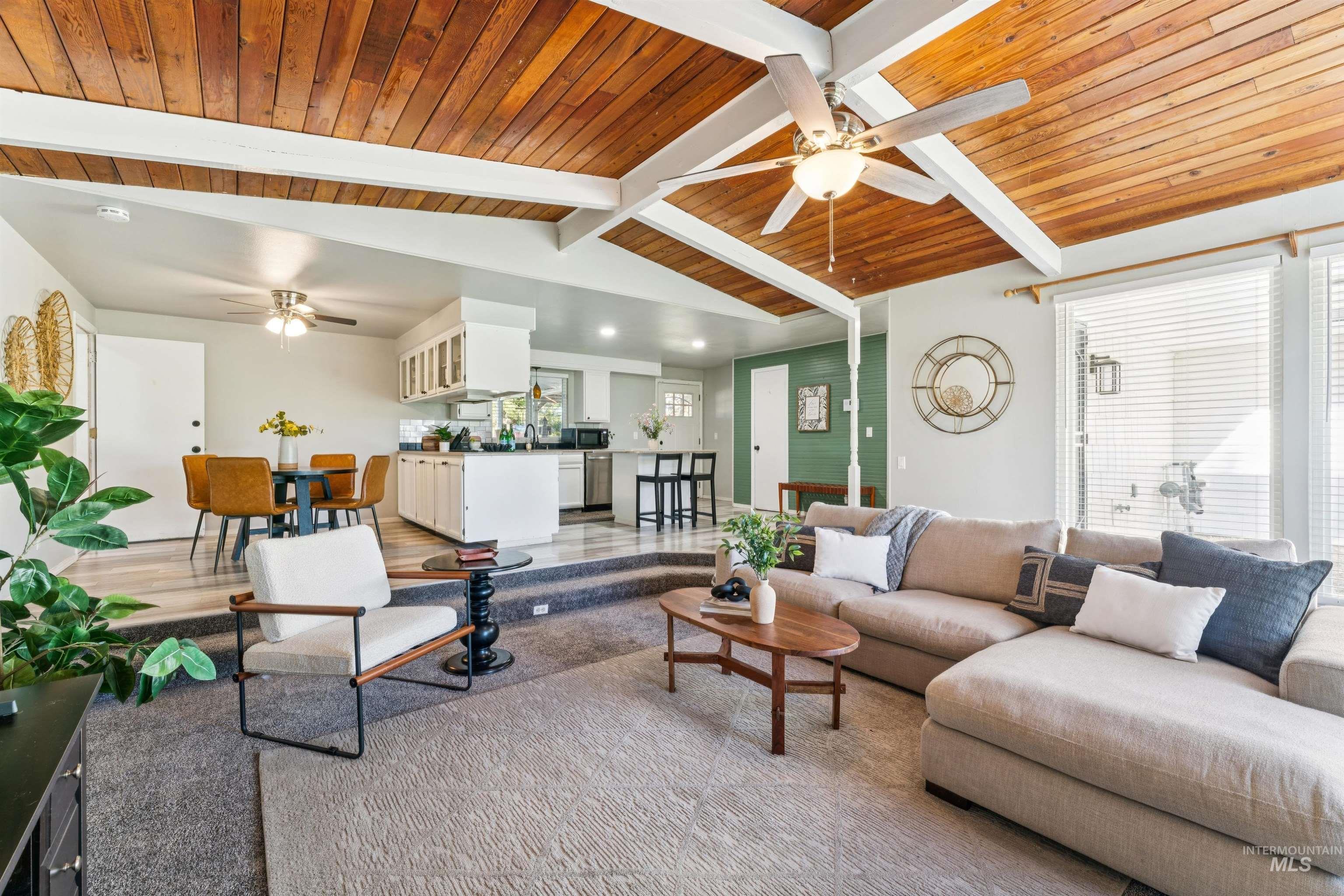 Living area with ceiling fan and wooden ceiling