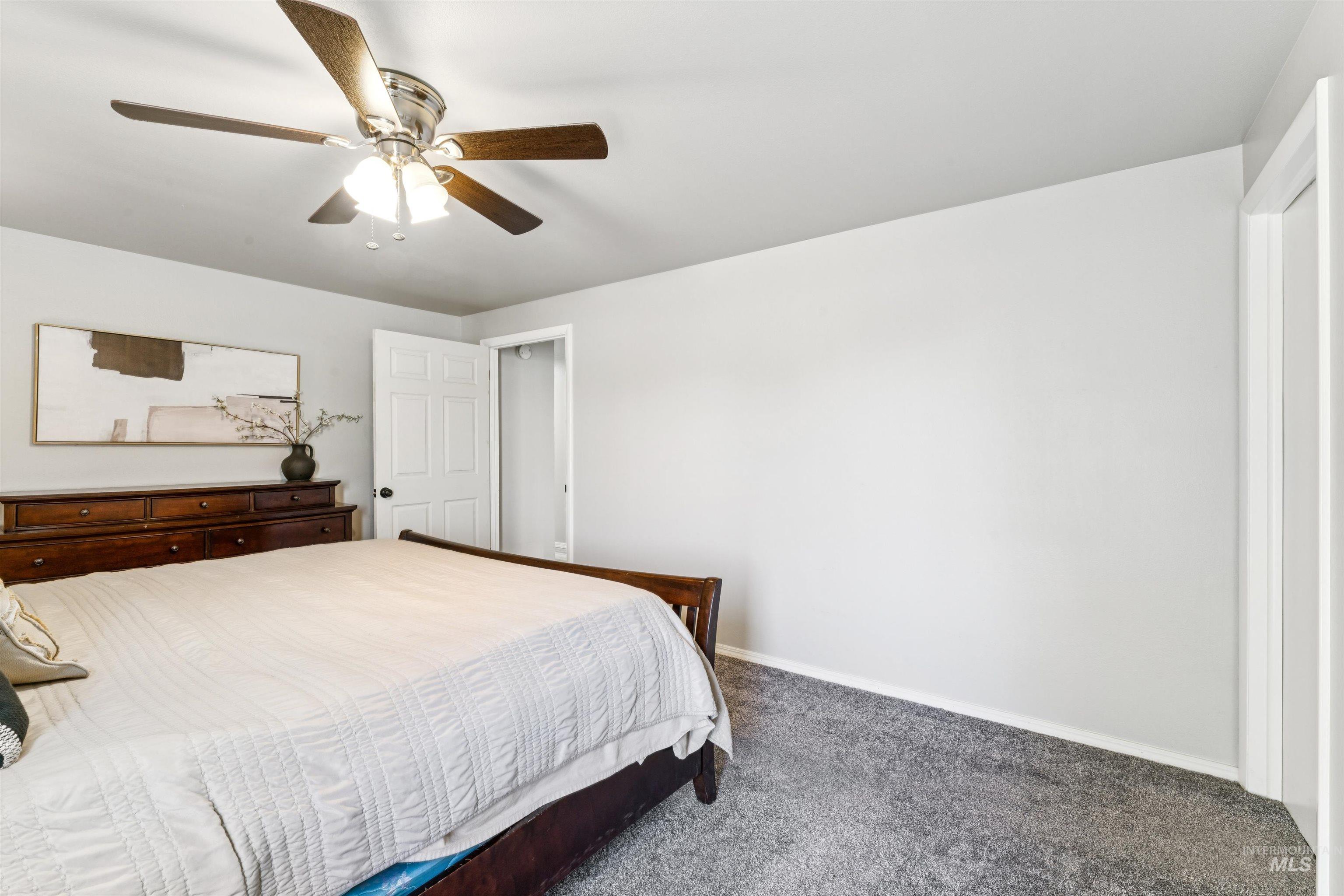 Bedroom featuring carpet and a ceiling fan