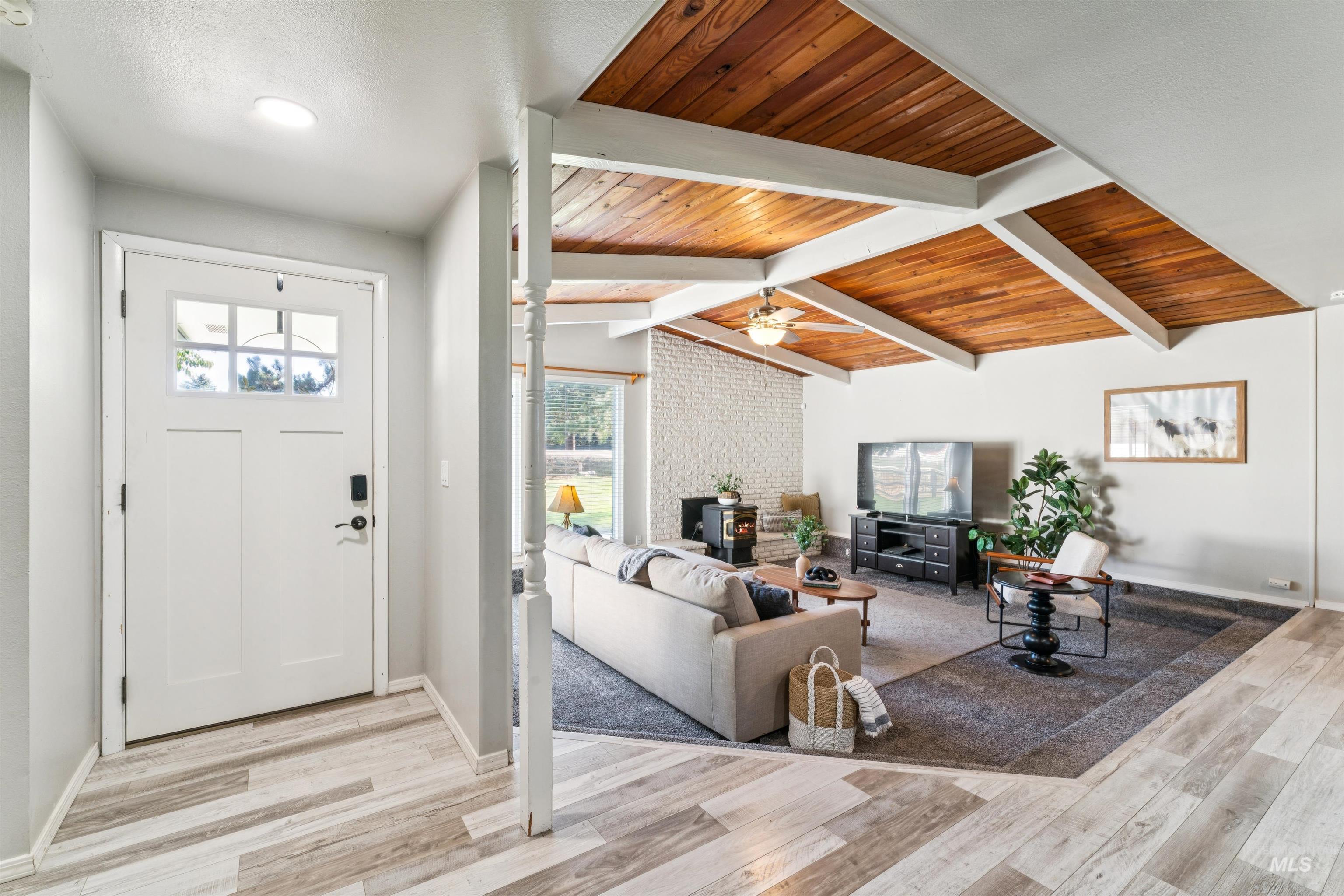 Entryway with light wood-style flooring and wood ceiling