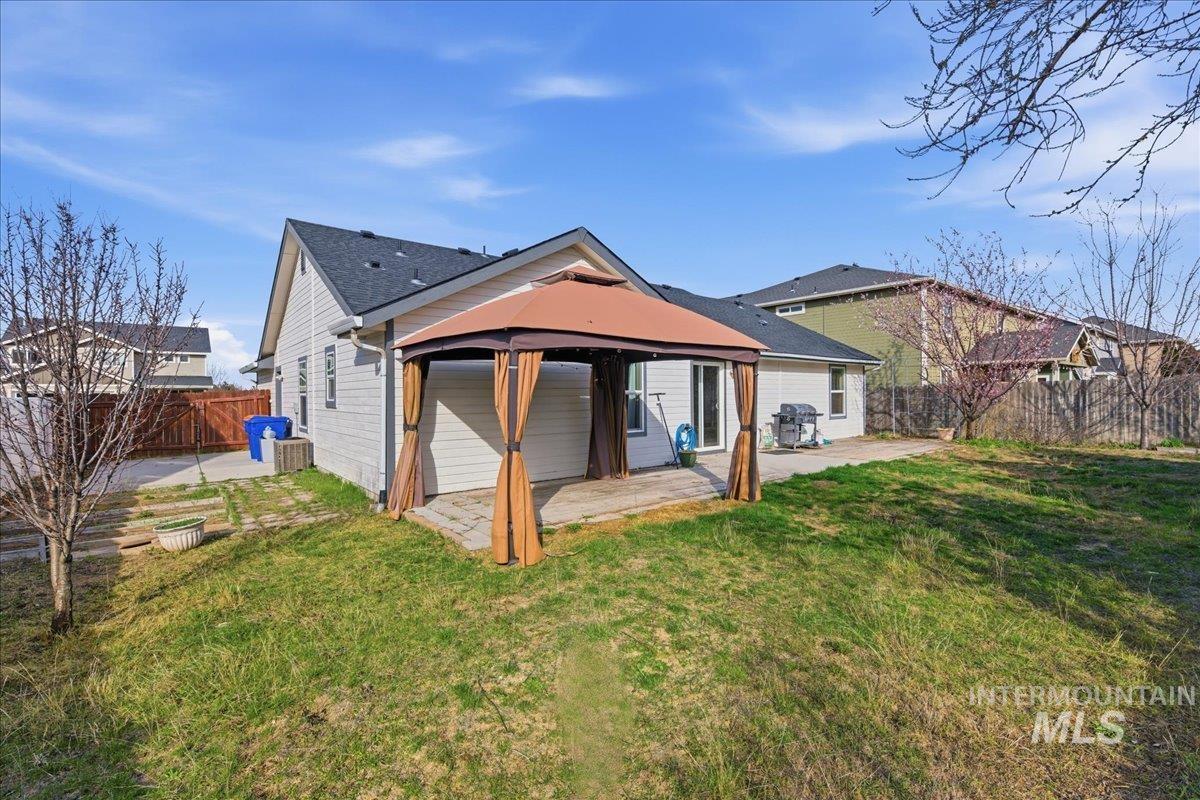 Rear view of property featuring a patio and a fenced backyard
