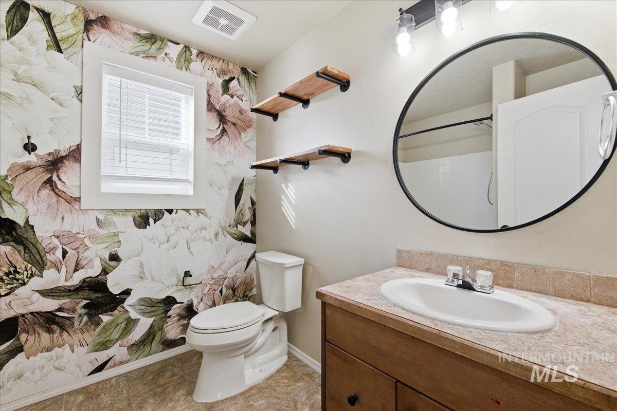 Full bath featuring vanity and a shower