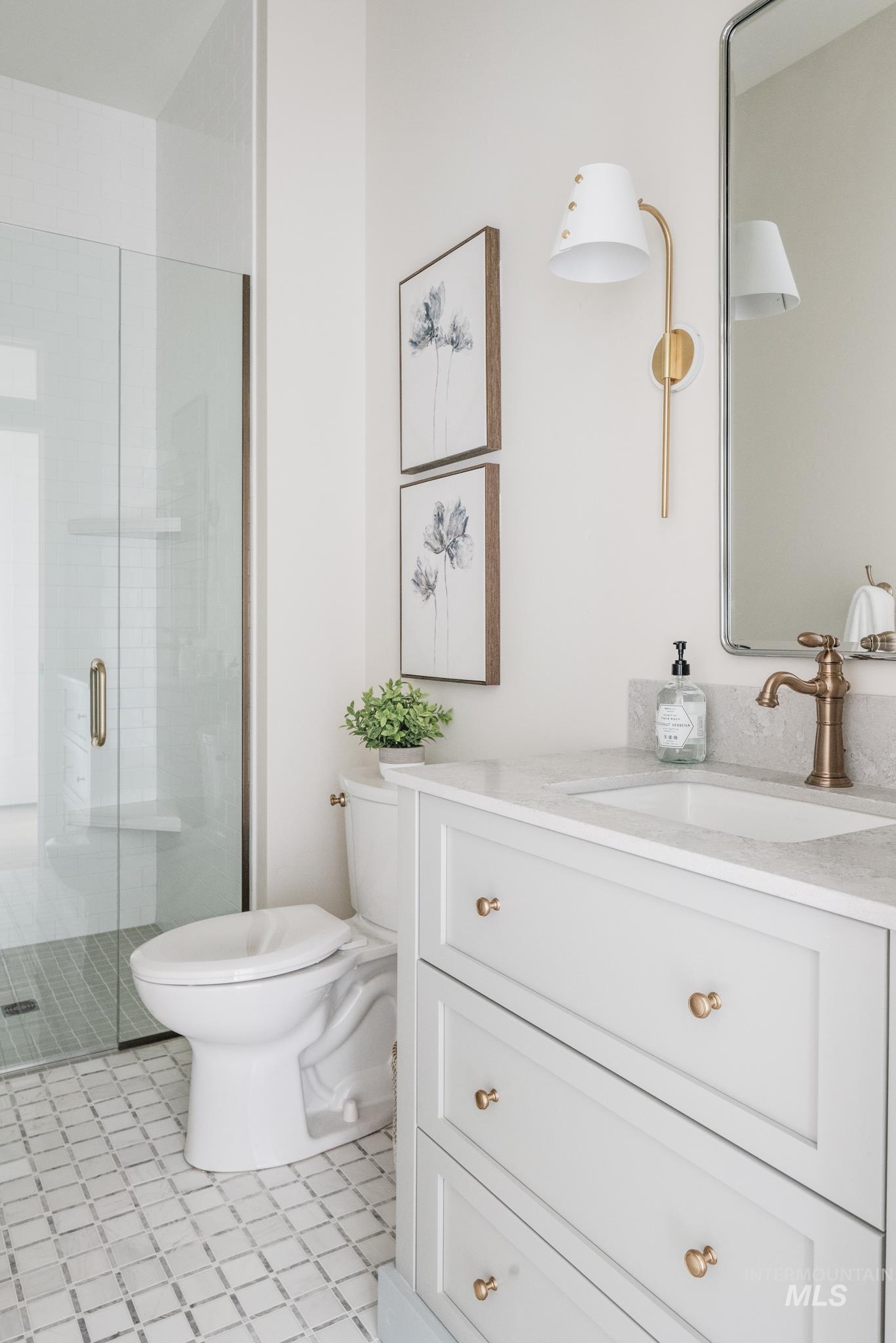 Bathroom with vanity, a shower stall, and light tile patterned floors
