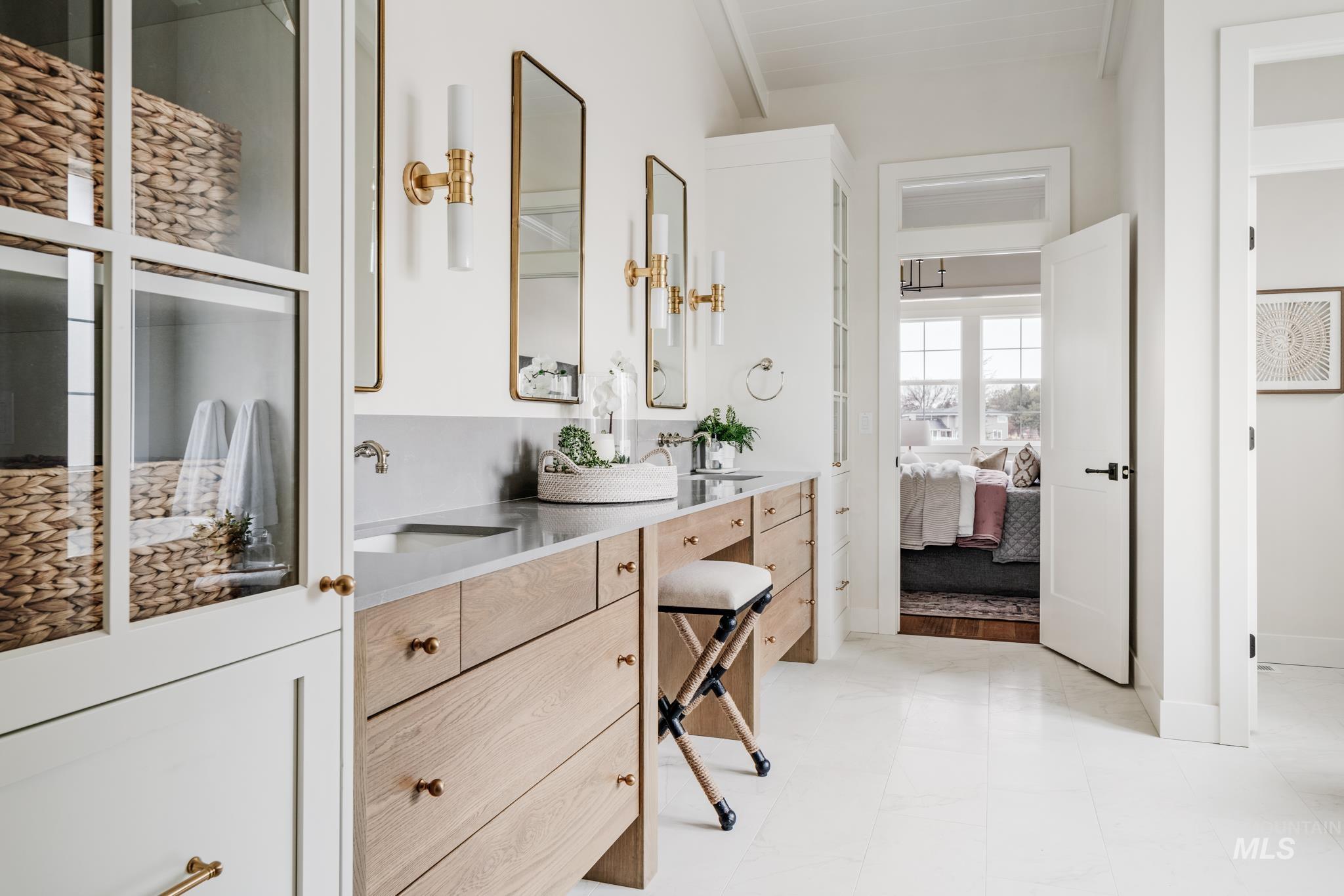 Ensuite bathroom with double vanity and baseboards