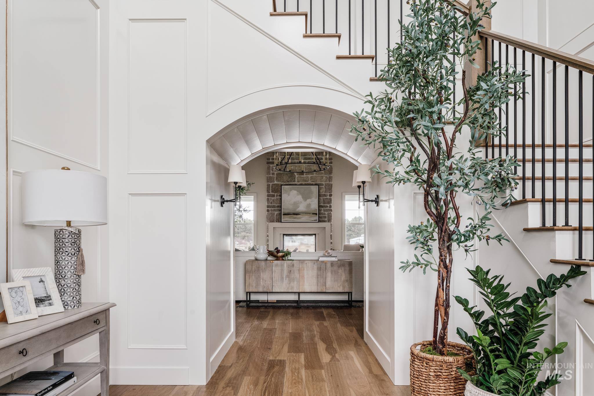 Corridor with wood finished floors and stairway