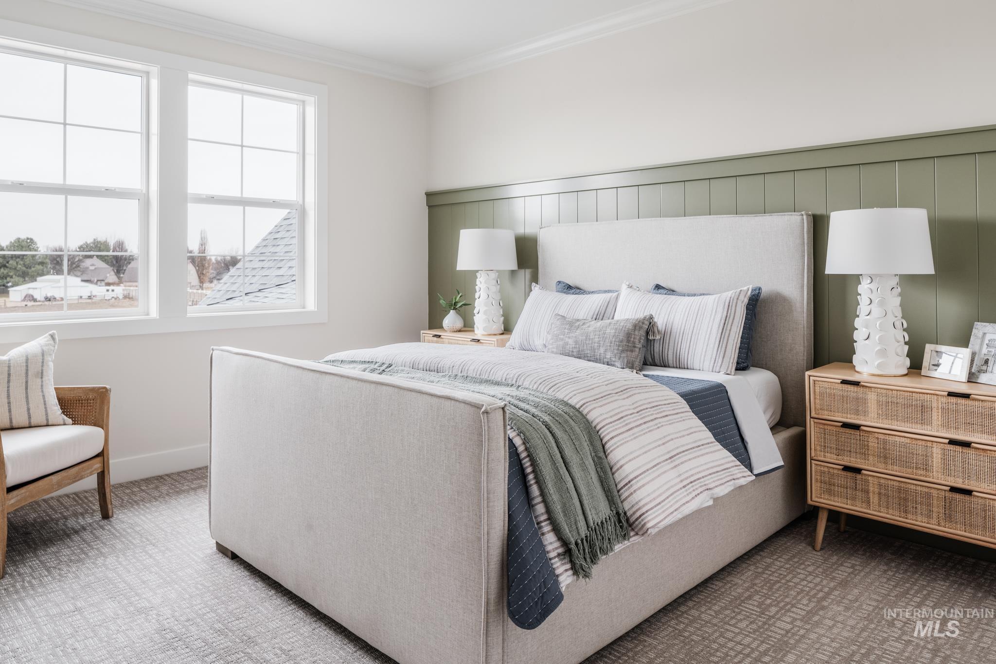 Bedroom with ornamental molding and carpet