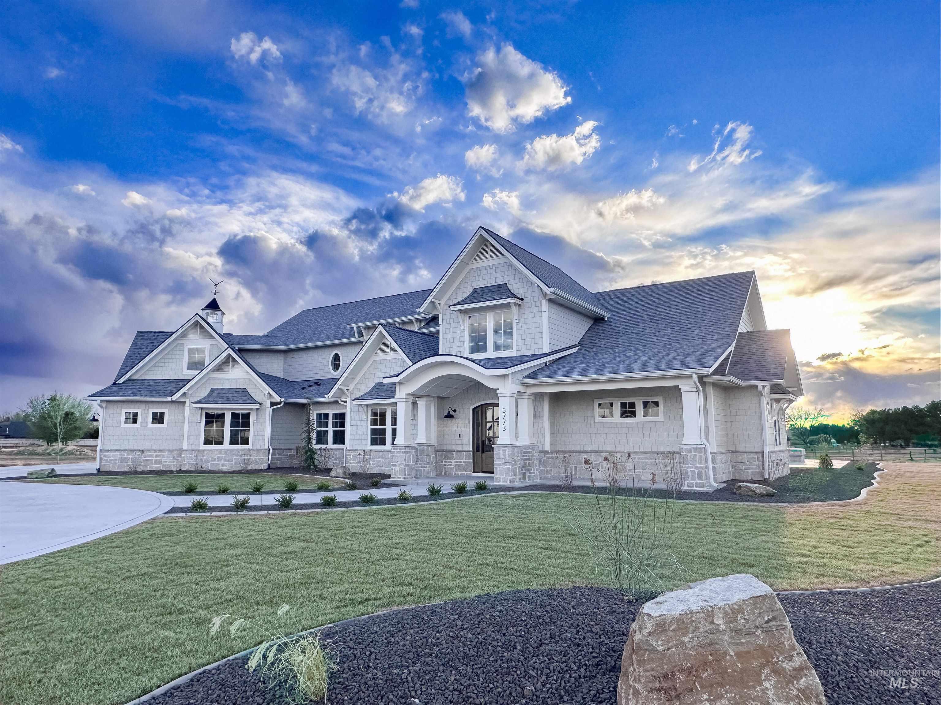 Craftsman-style home with a shingled roof, a front lawn, and a chimney