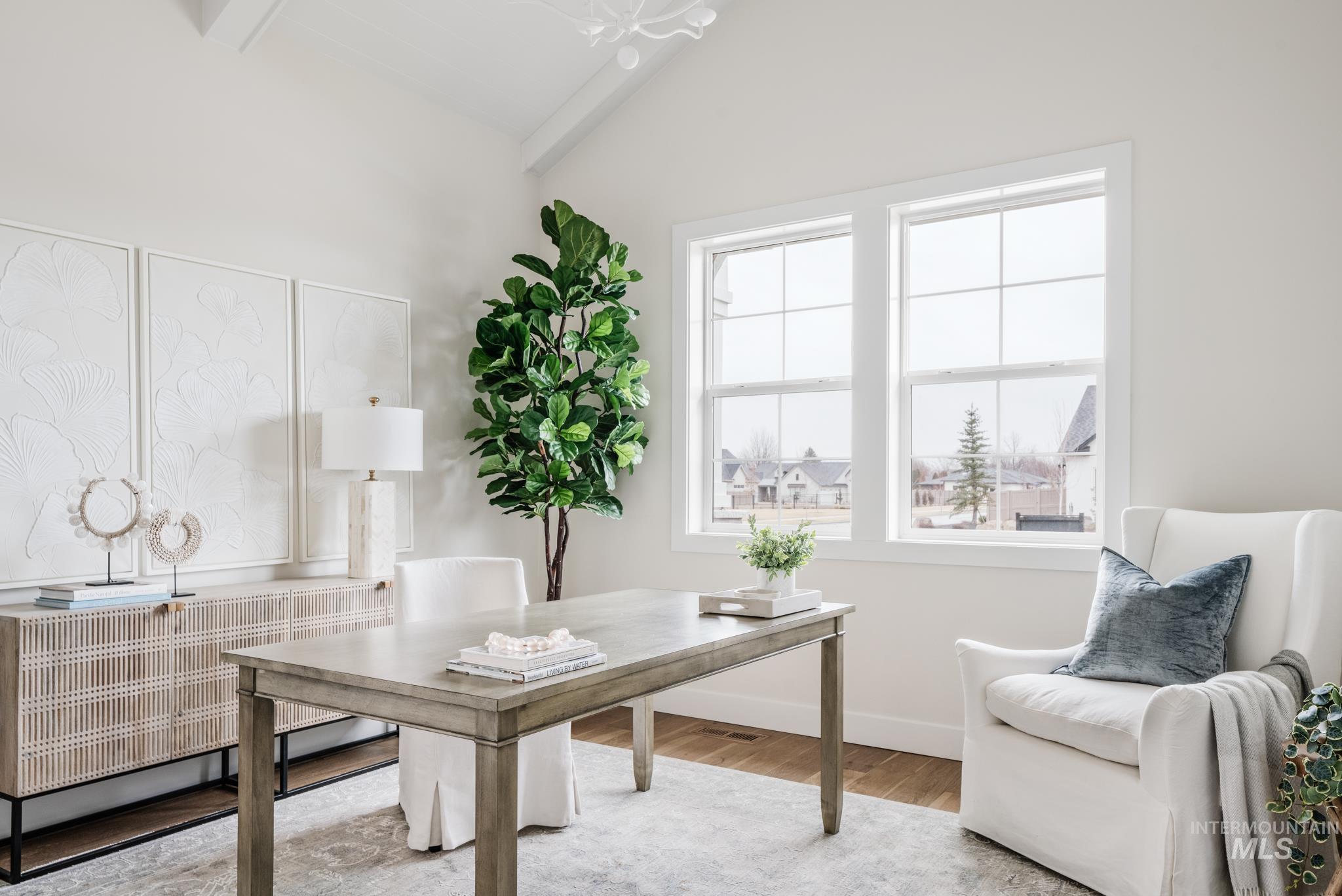 Home office featuring wood finished floors and radiator