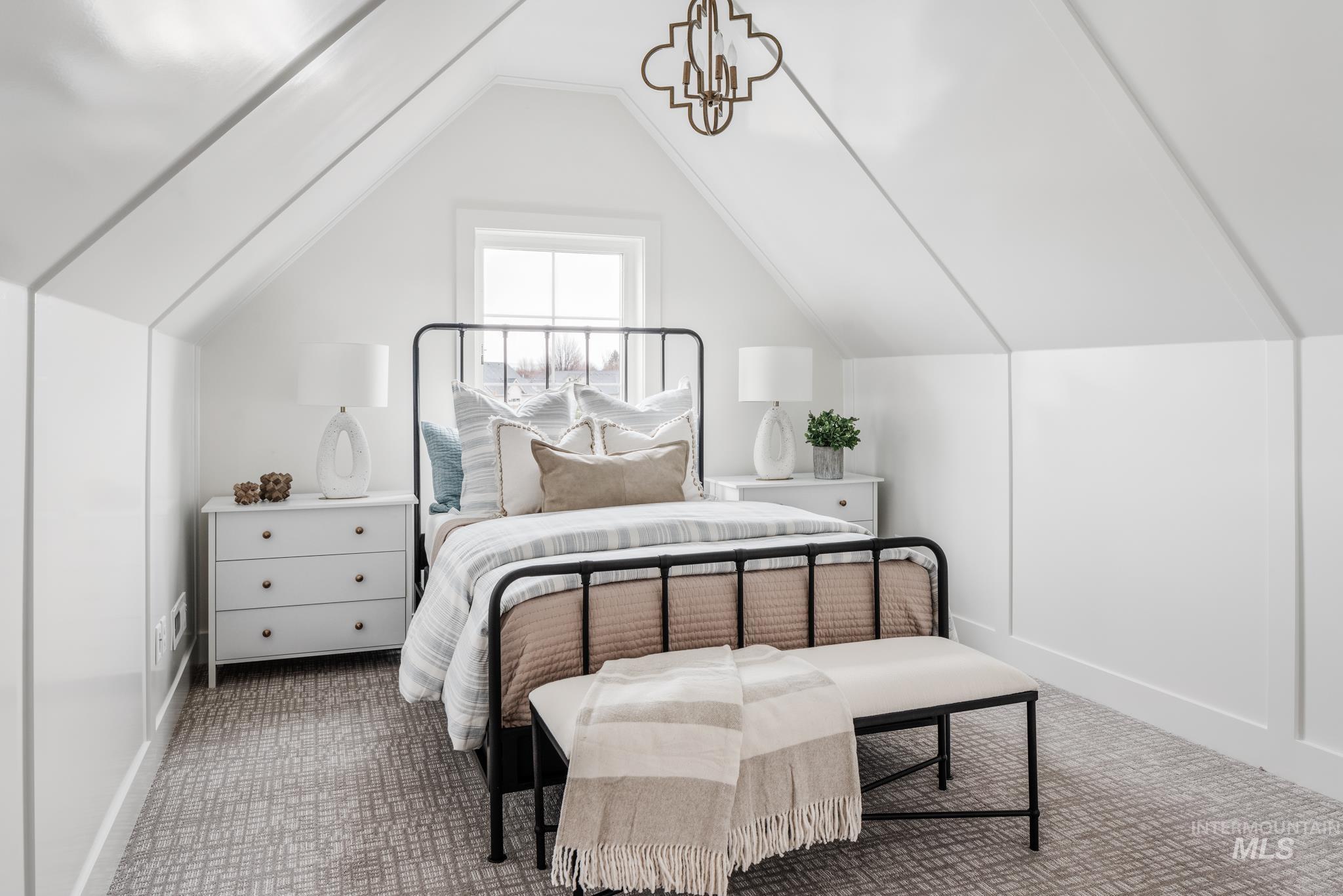 Bedroom with carpet flooring and lofted ceiling