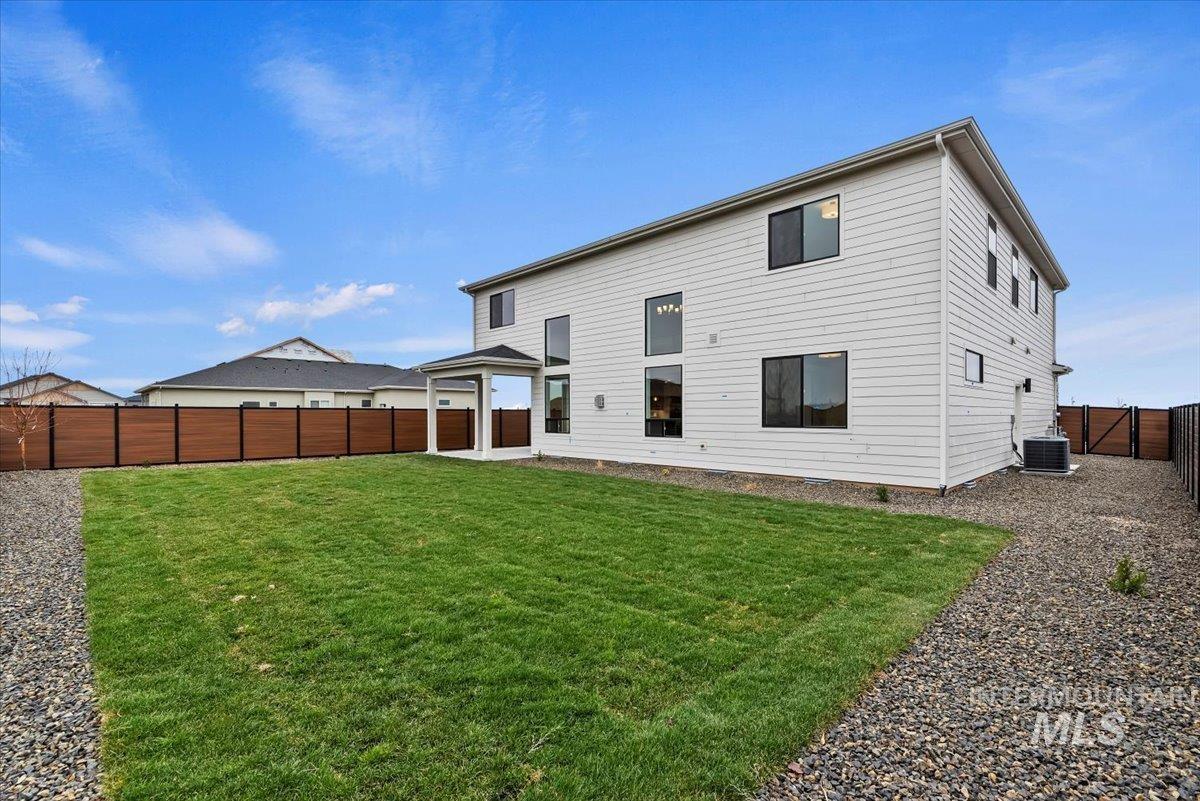 Back of property with a fenced backyard and a gate