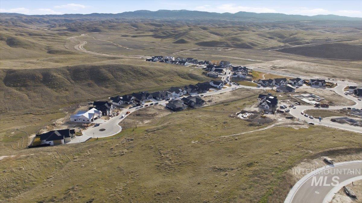 Aerial view of property's location with a mountainous background