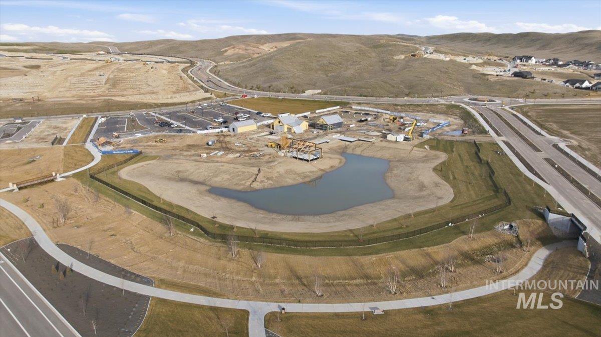 Aerial view of property and surrounding area featuring a water and mountain view