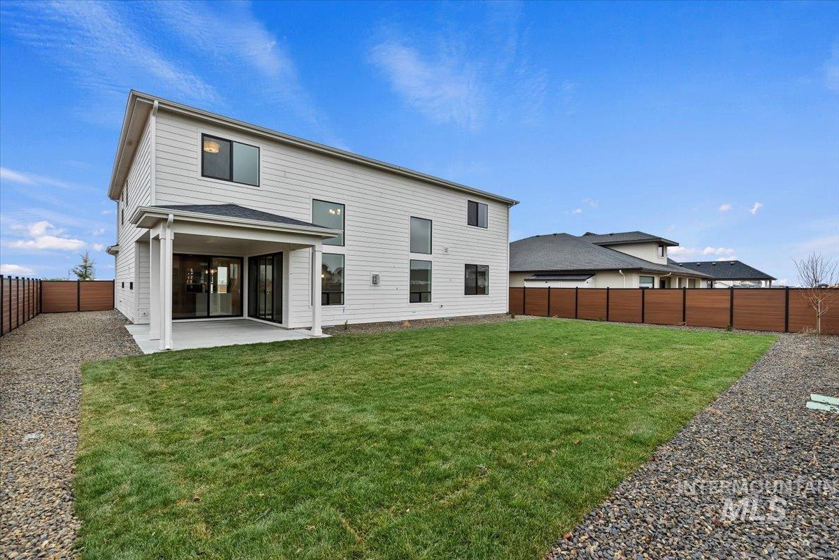 Rear view of property featuring a fenced backyard and a patio area