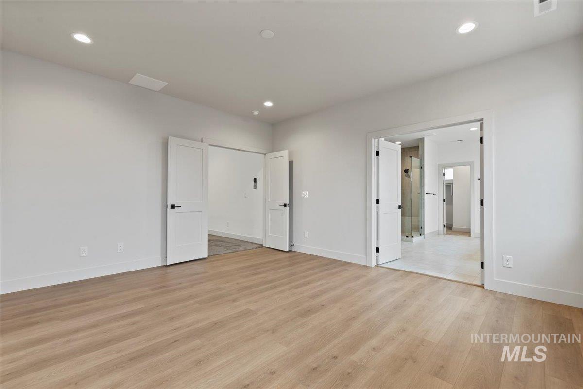 Unfurnished bedroom with light wood-type flooring and recessed lighting
