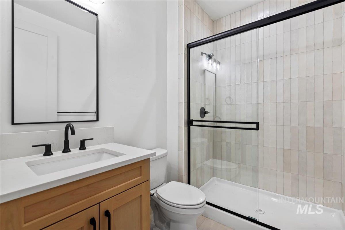 Full bathroom featuring vanity and a stall shower
