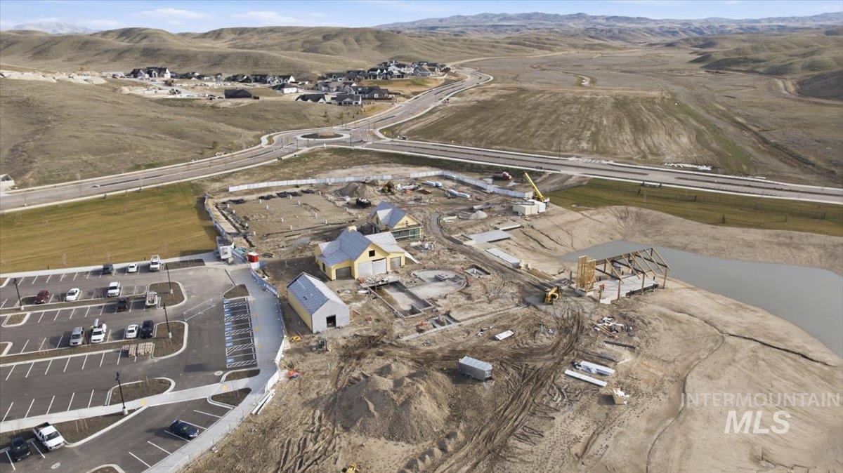 Aerial view of property and surrounding area with a mountainous background