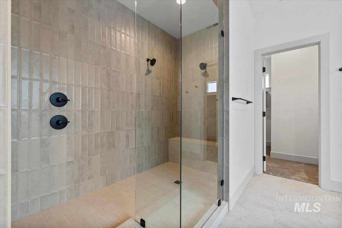 Bathroom with a walk in shower and tile patterned floors
