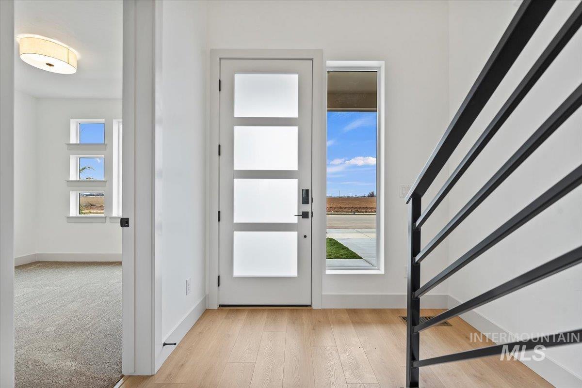 Foyer entrance featuring light wood-type flooring and stairs