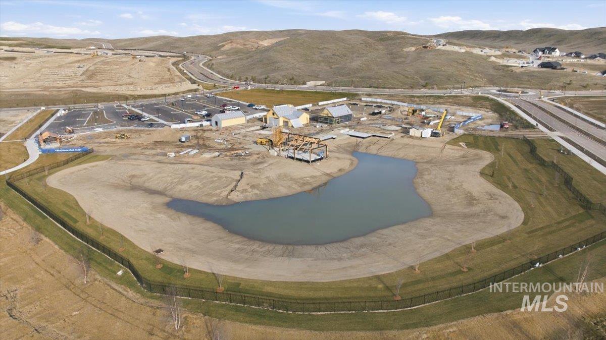 Aerial view of property's location with a water and mountain view