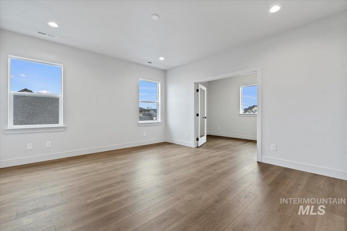 Unfurnished room with light wood-style flooring and recessed lighting