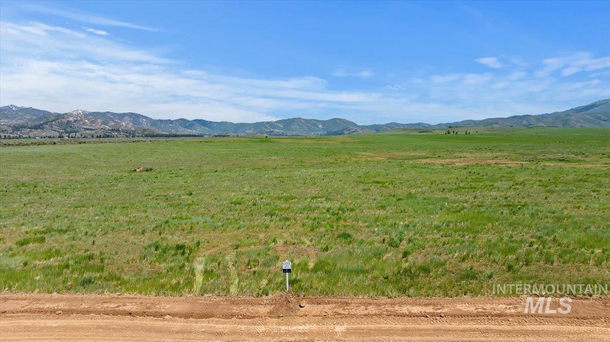 View of mountain backdrop with rural landscape