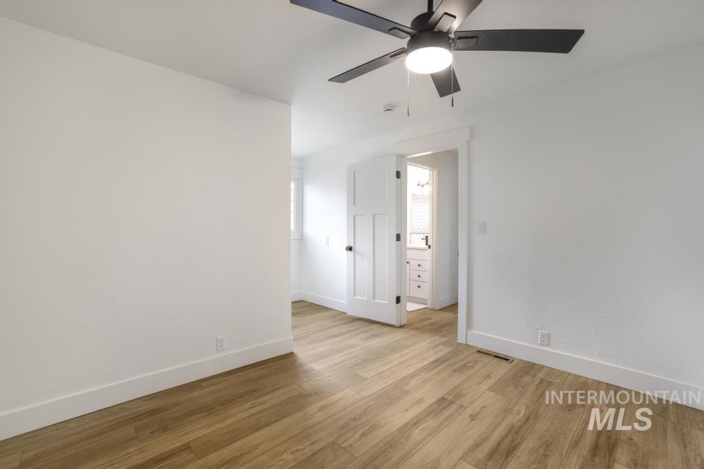 Spare room featuring light wood-type flooring and ceiling fan
