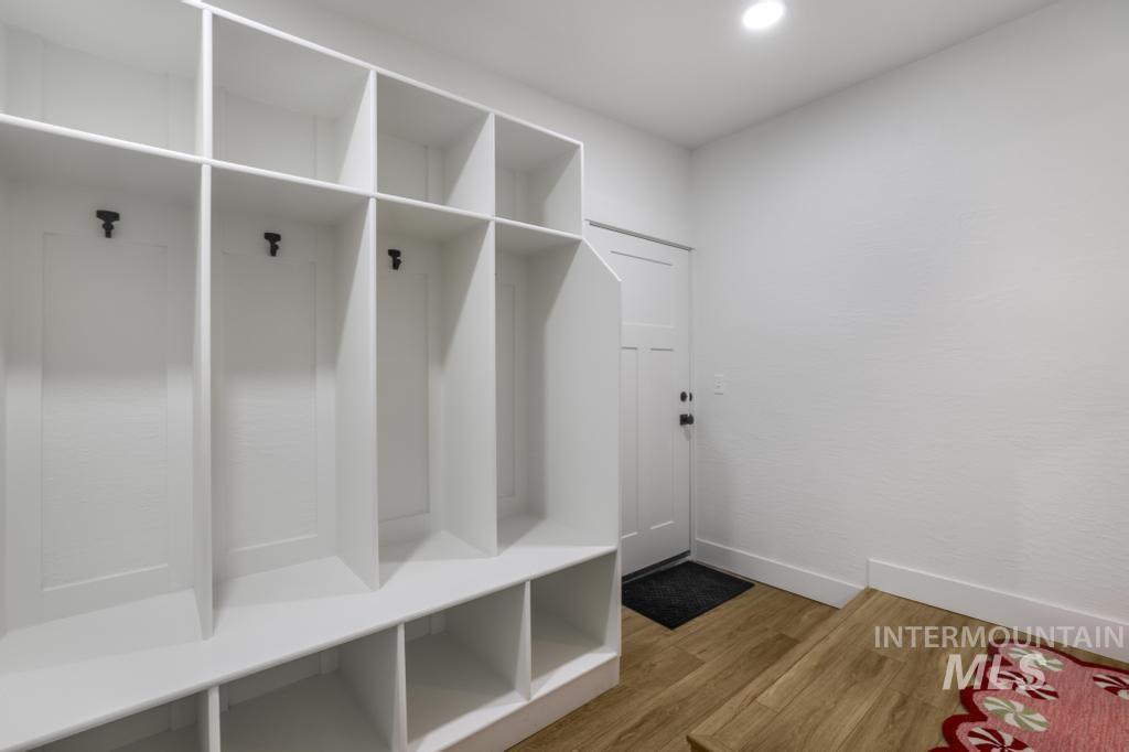 Mudroom featuring light wood-style floors and recessed lighting
