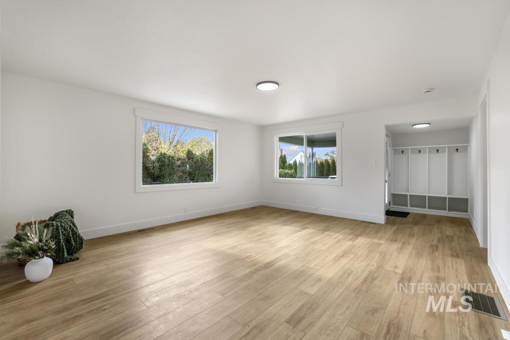 Unfurnished room with light wood-type flooring and baseboards