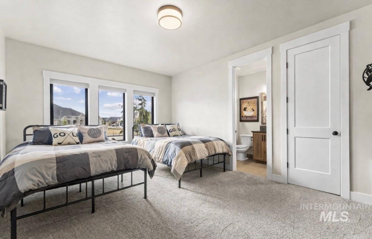 Bedroom with carpet floors and ensuite bathroom