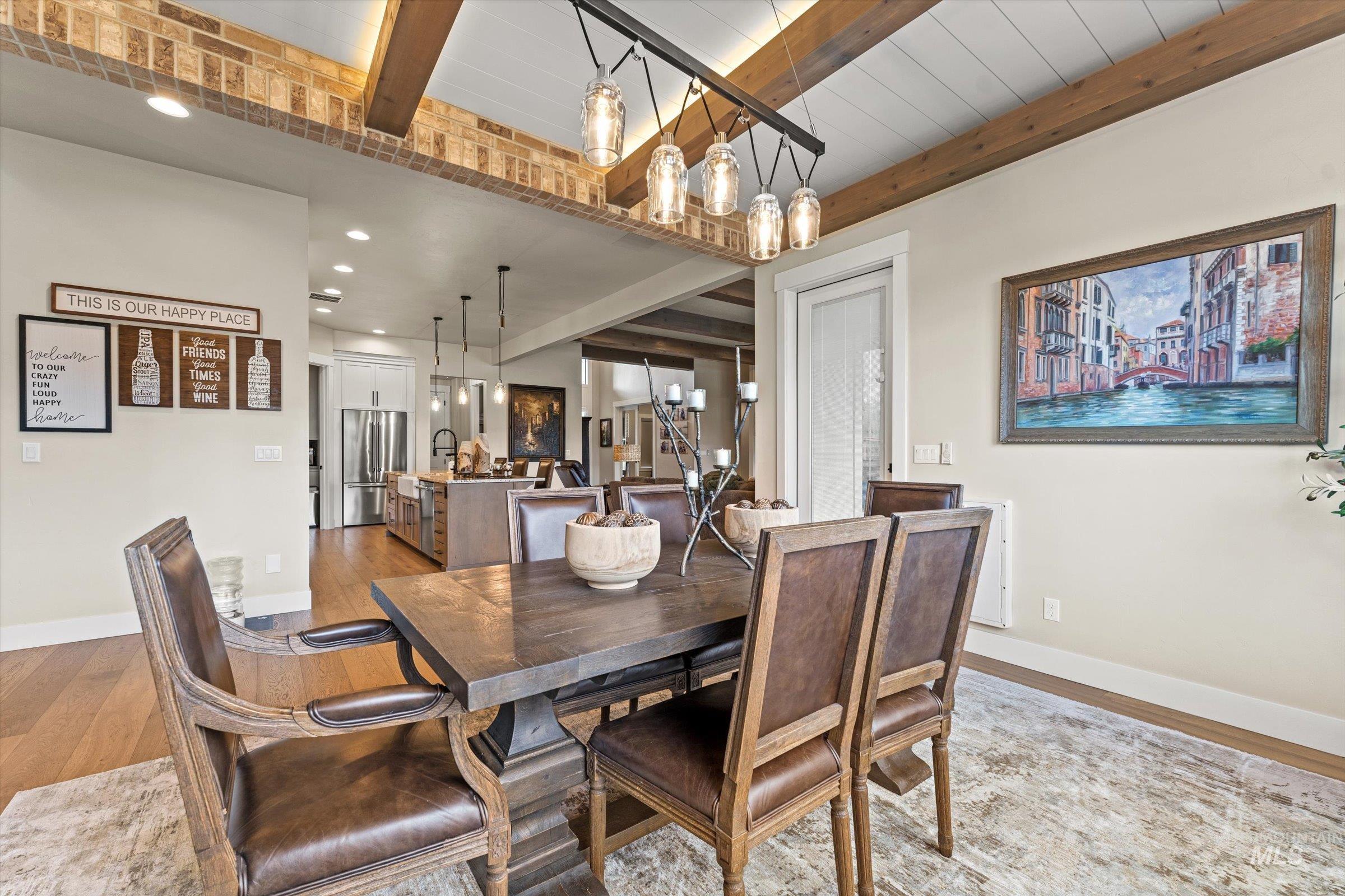 Dining room with beam ceiling, wood finished floors, and recessed lighting