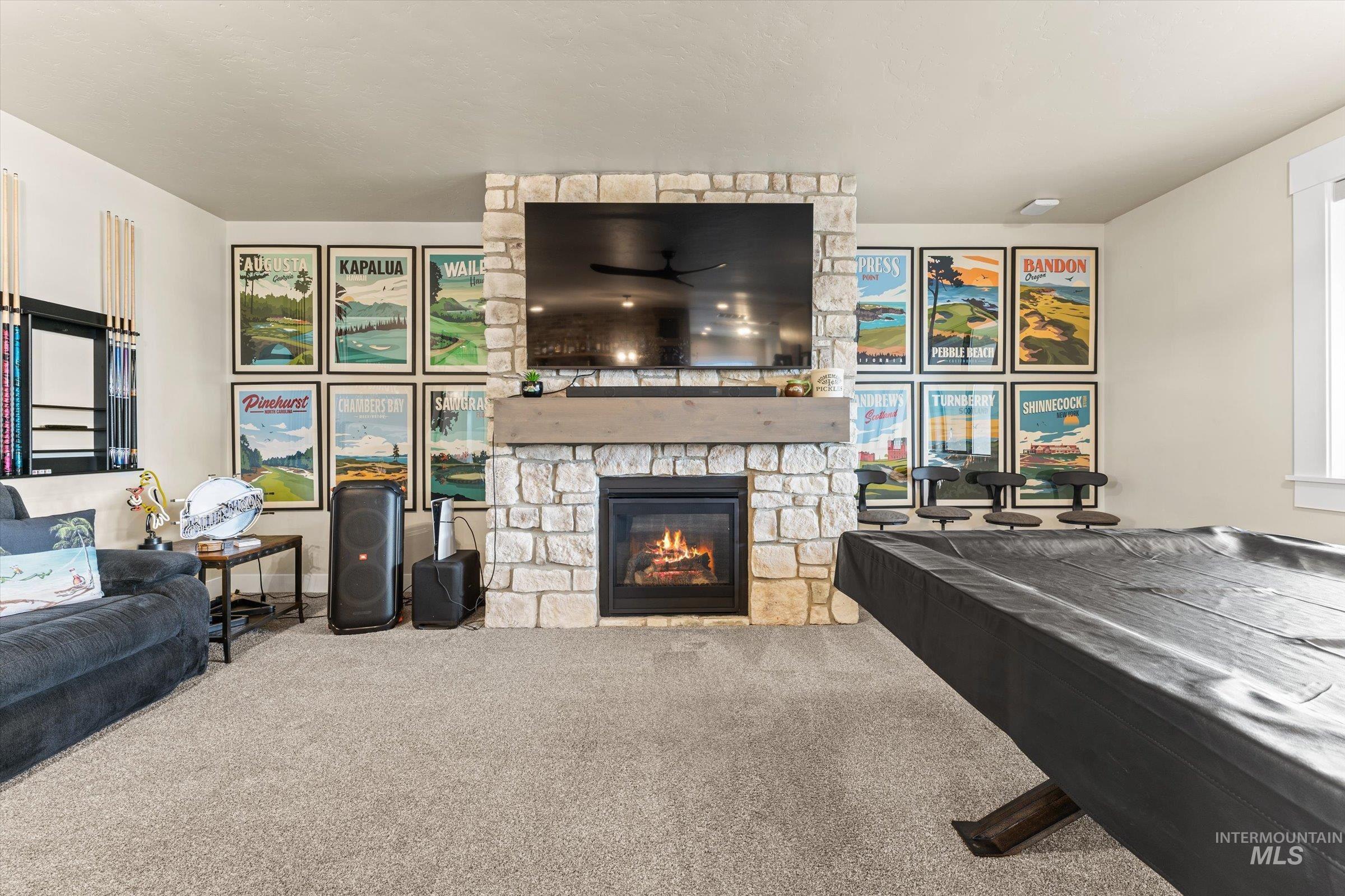 Carpeted living room with a fireplace and ceiling fan