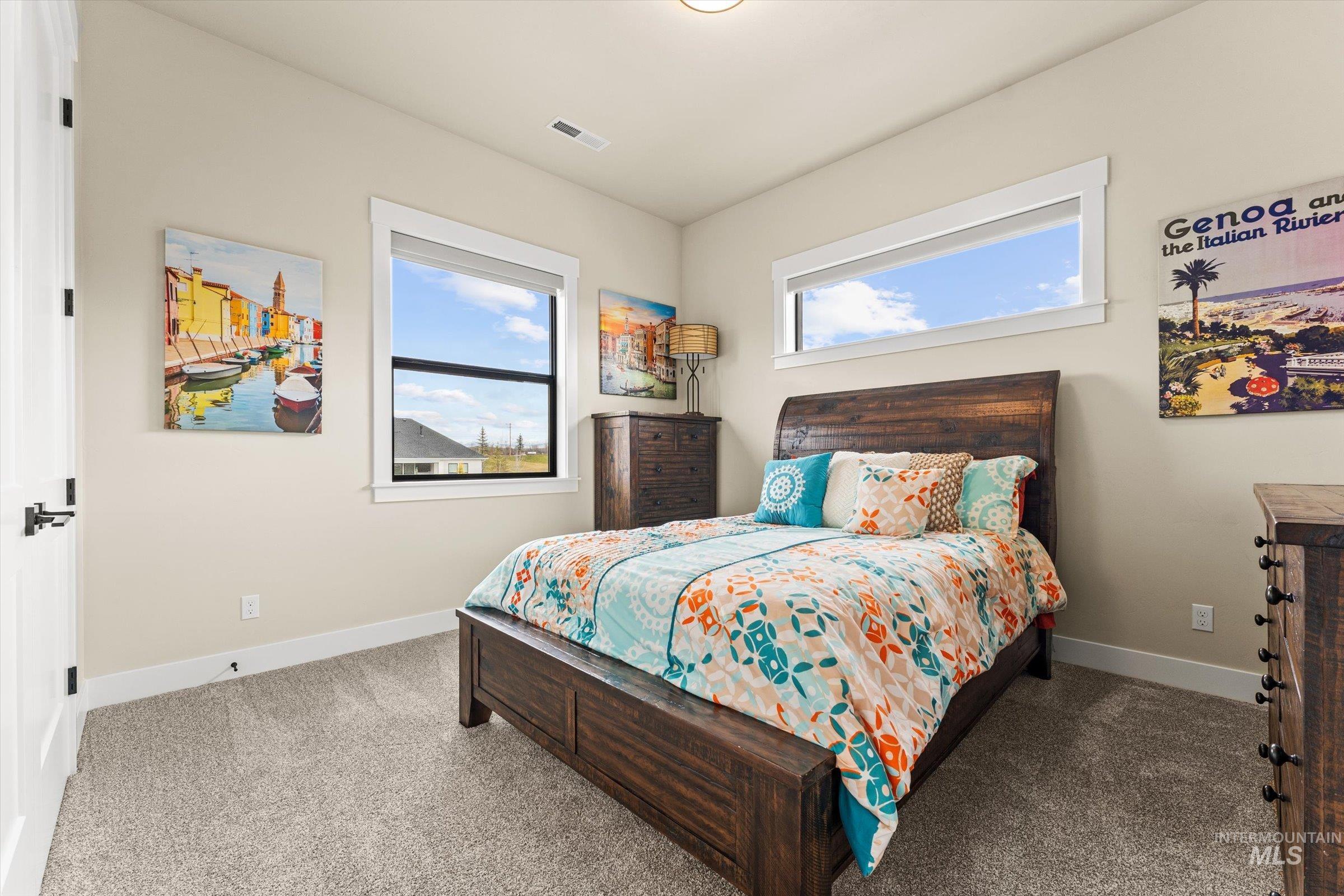 Carpeted bedroom featuring baseboards