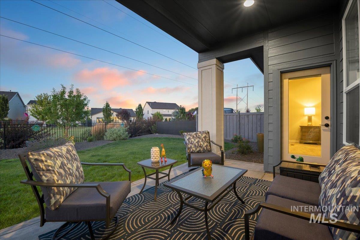 Fenced backyard with a patio and outdoor lounge area