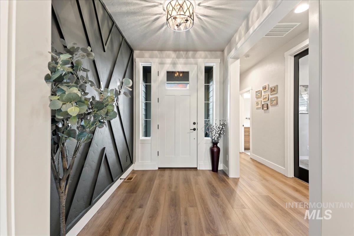Entryway featuring wood finished floors and baseboards