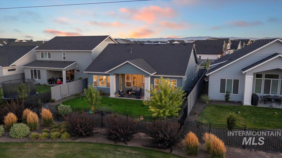 Back of property featuring a patio, a fenced backyard, and a residential view