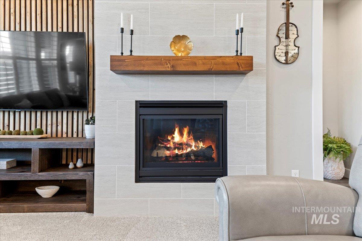Detailed view of a tile fireplace and carpet floors