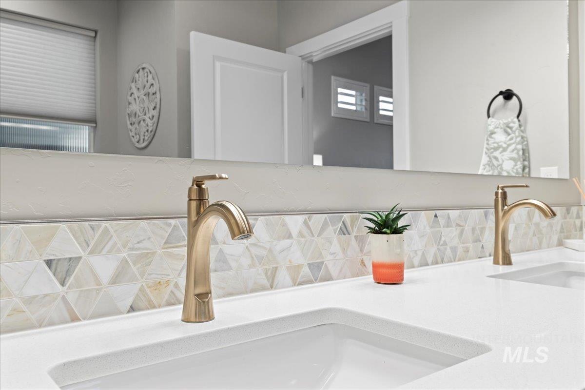 Detailed view of tasteful backsplash and double vanity