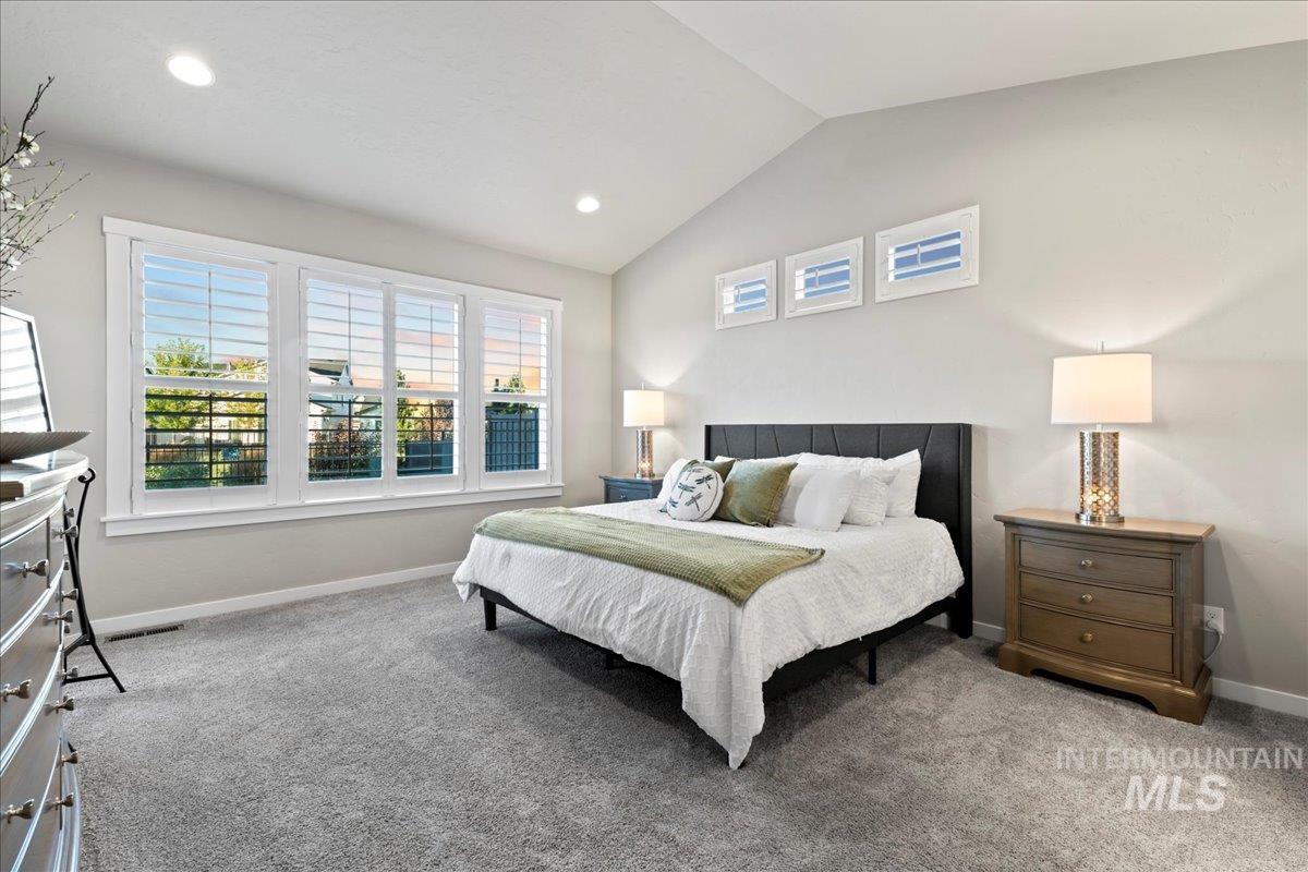 Bedroom with lofted ceiling, carpet flooring, and recessed lighting