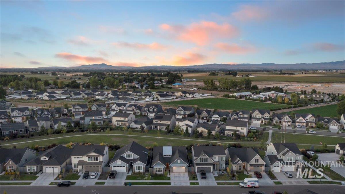 Aerial view of residential area featuring a mountainous background