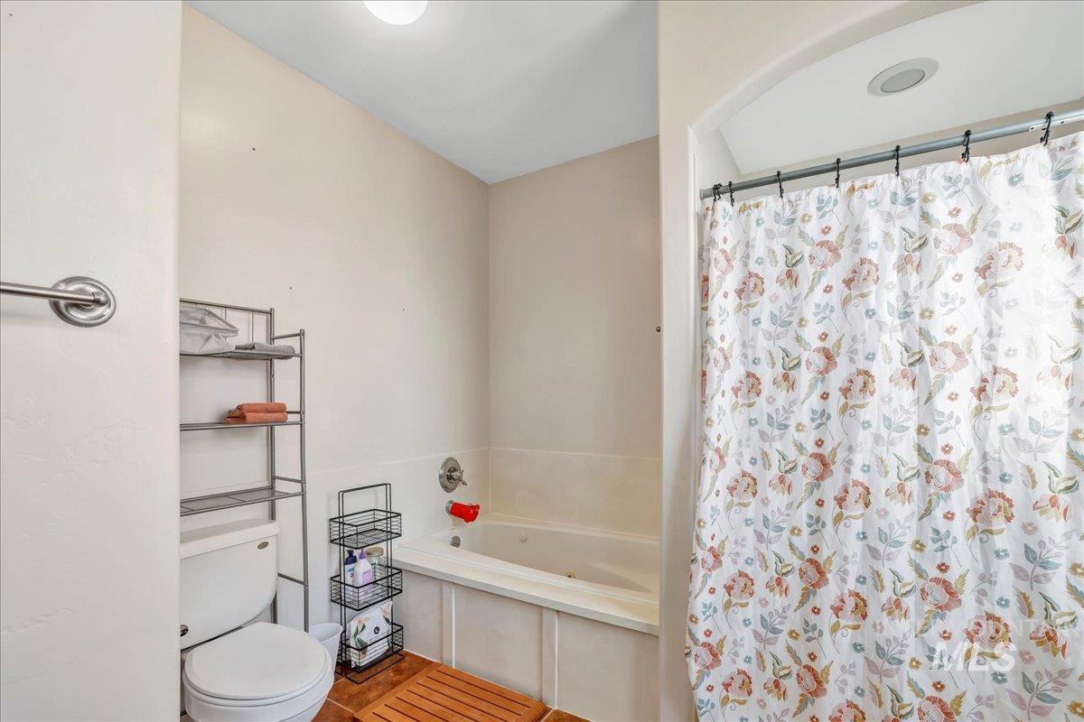 Full bathroom featuring a bath and a shower with curtain